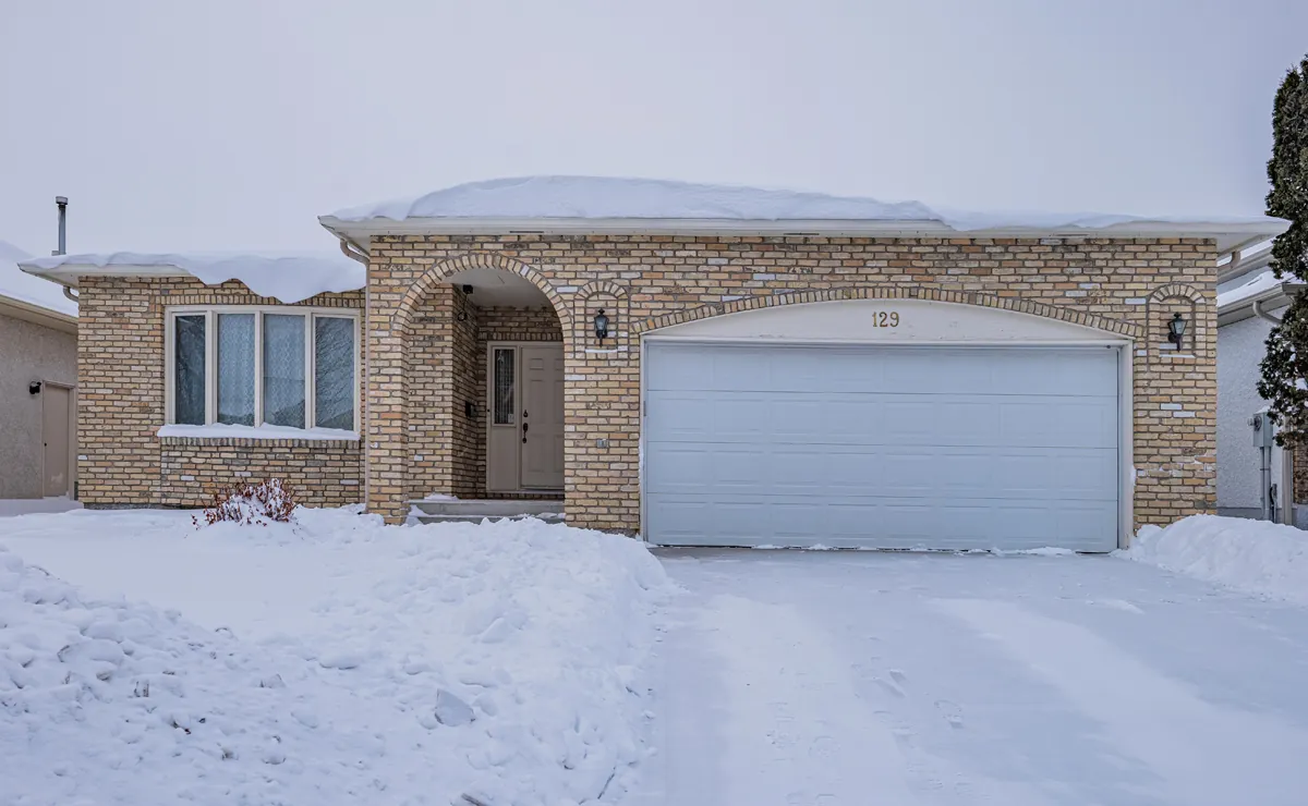 Before: the front of the house and garage in winter