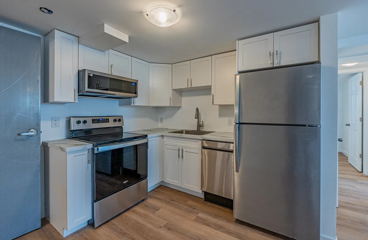 Renewed suite kitchen in white shaker cabinetry with stainless appliances