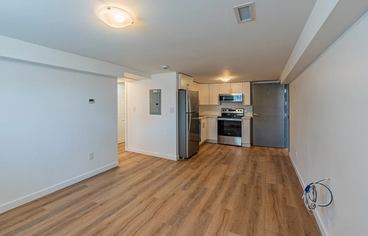 Living area of a finished suite, kitchen through the opening