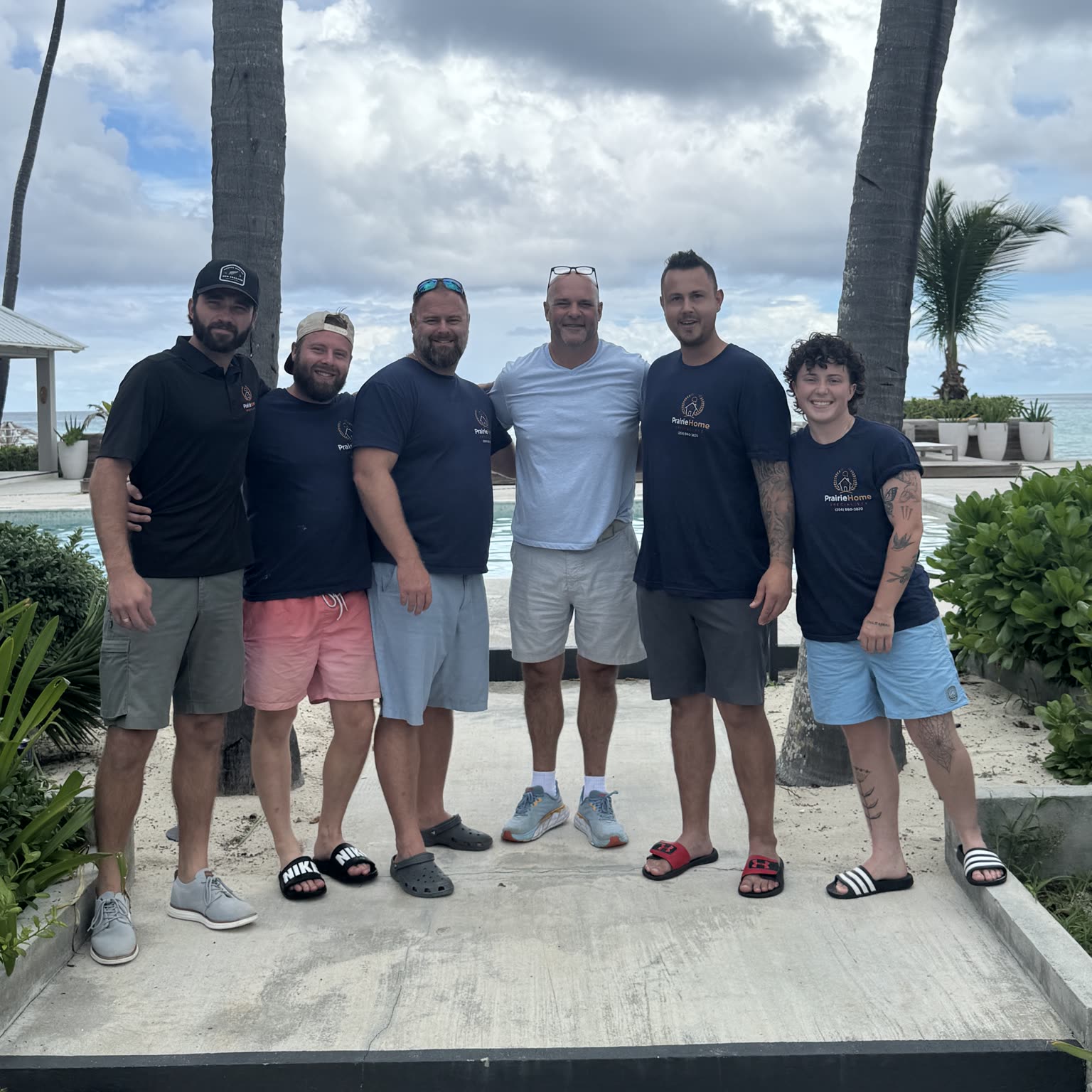 Bryan Baeumler with the PHS Renovations team, outdoors under palm trees